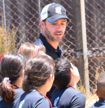 WEBJimmie Johnson running around the track with Running club kids who had over 48 miles for the year.jpg